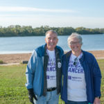 Picture of man and woman smiling and wearing 2019 Purple Stride t-shirts