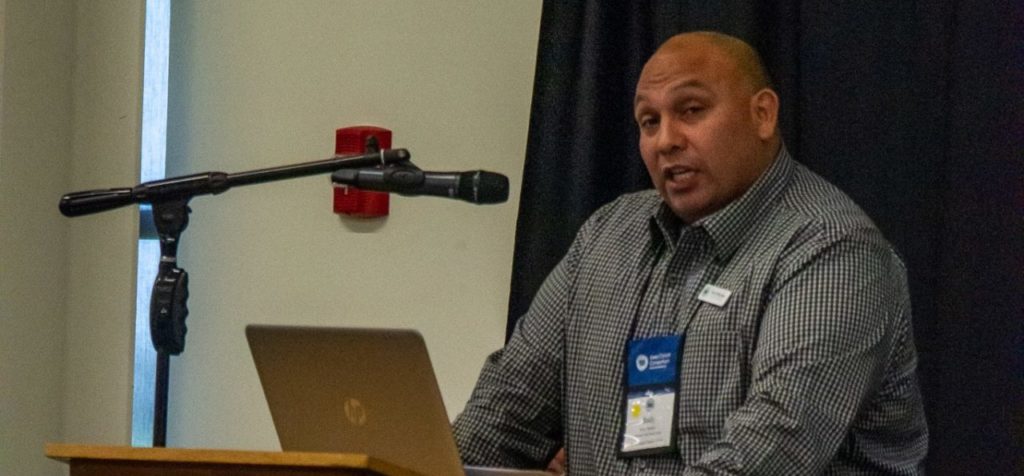 Board member speaking at the Iowa Cancer Summit microphone