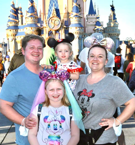 Abby and her family in front of Cinderella's Castle at Walt Disney World